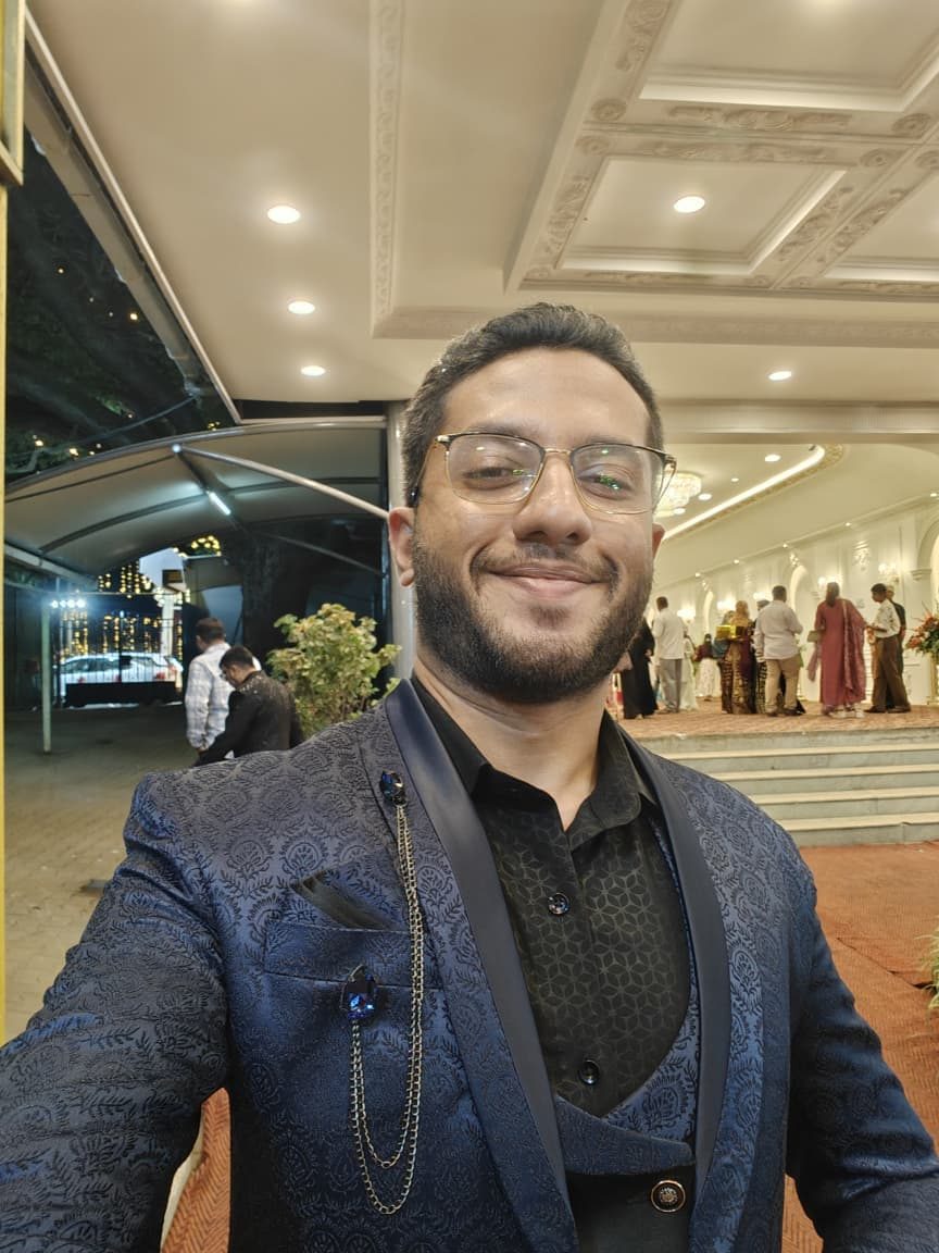 Abbas in a blue formal jacket at an evening event