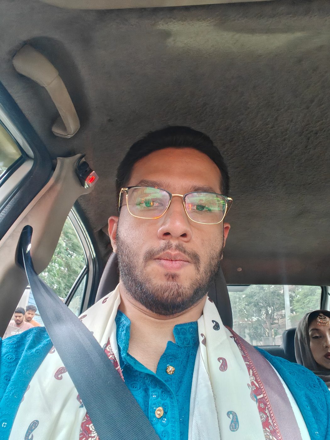 Abbas in a car in a blue kurta