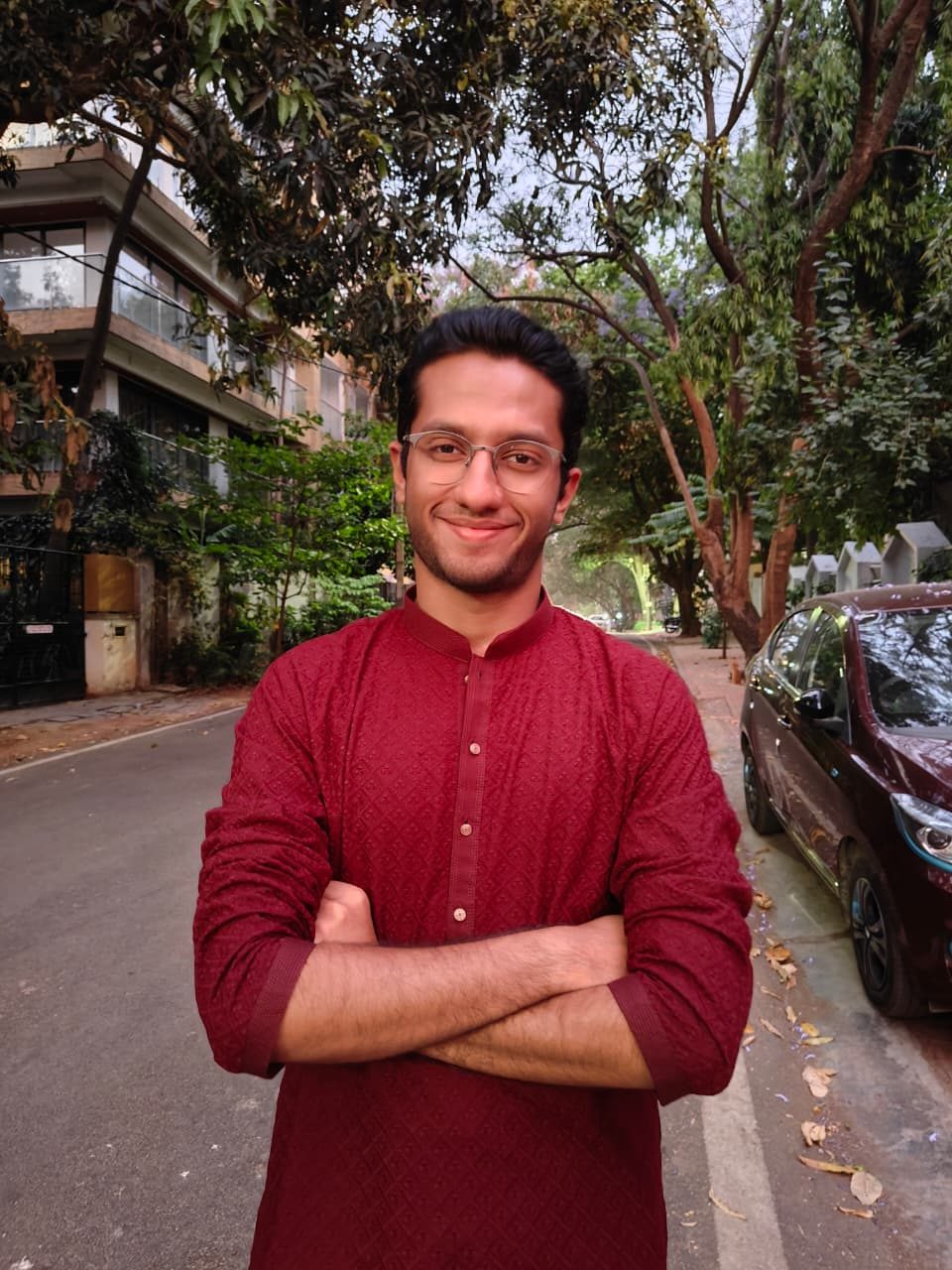 Abbas in a maroon kurta on a tree lined street
