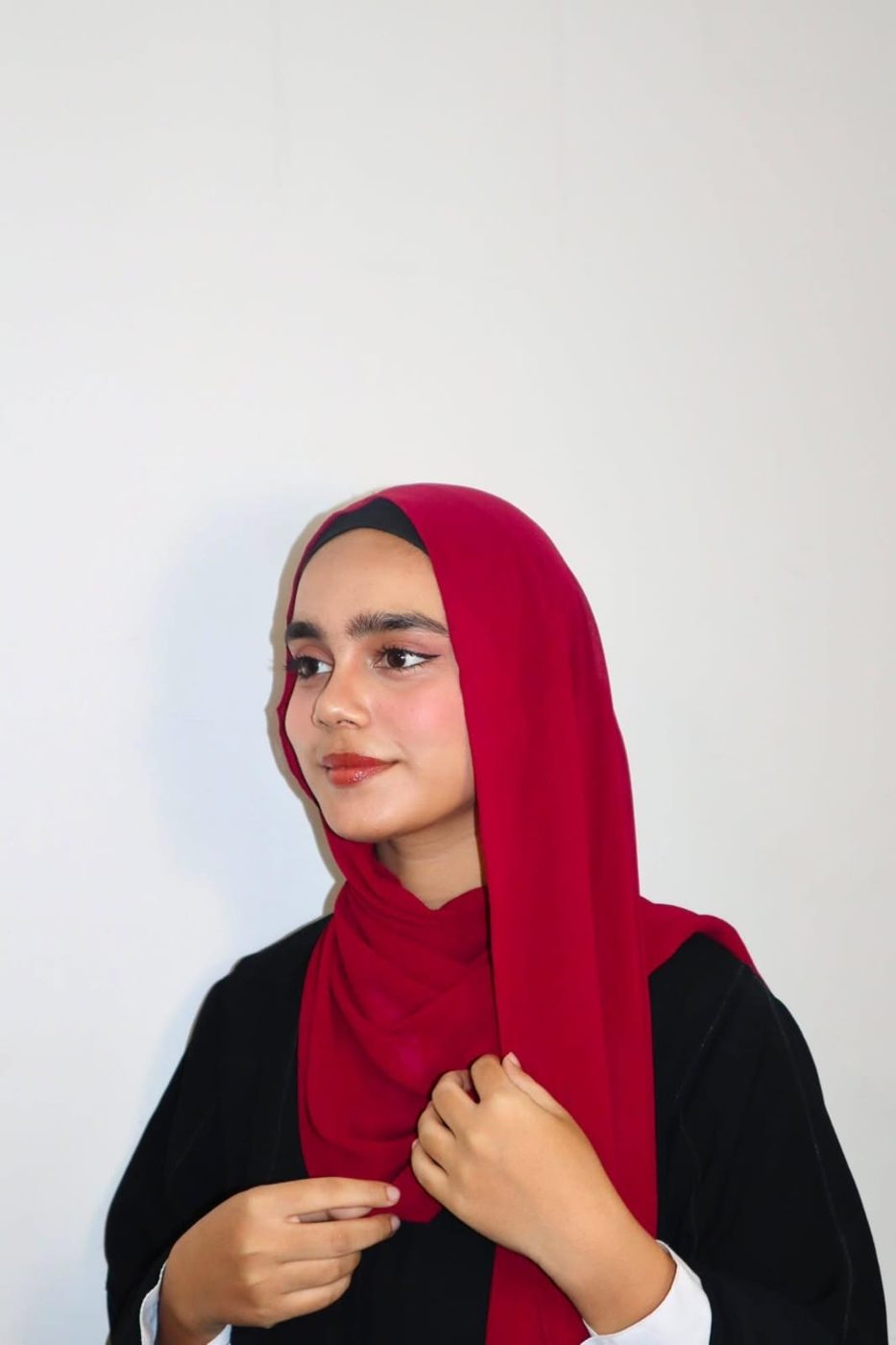 Arfa in a red hijab and black abaya